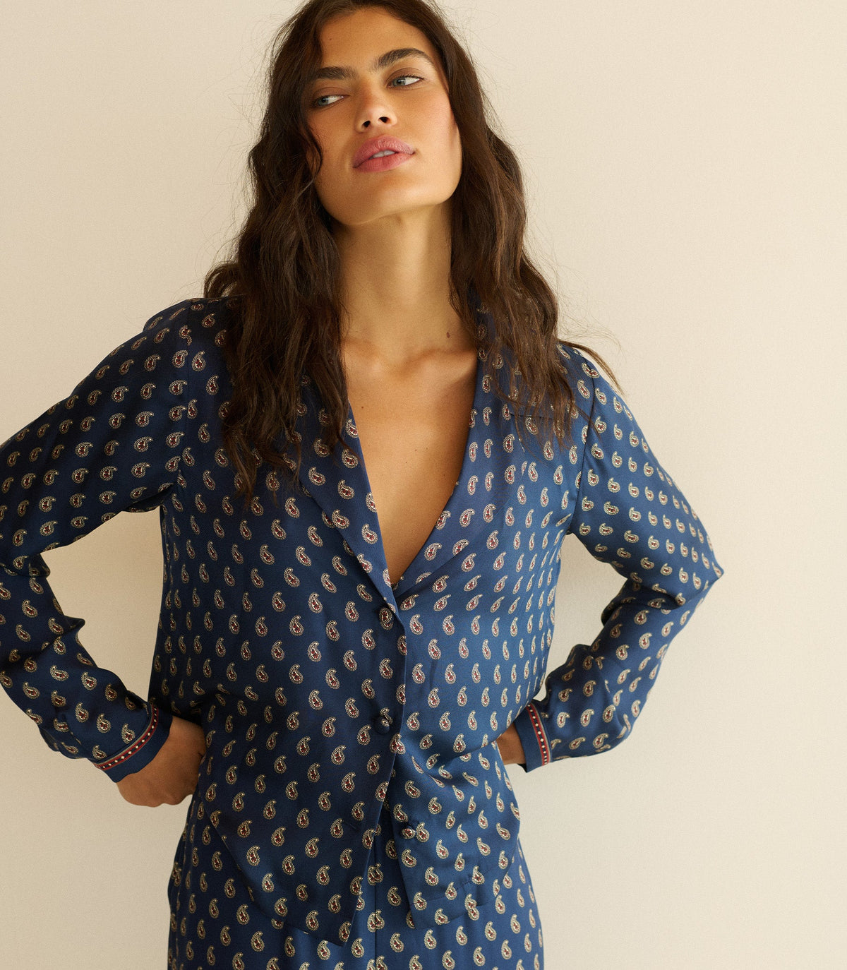 Woman wearing a blue paisley top with matching pants.